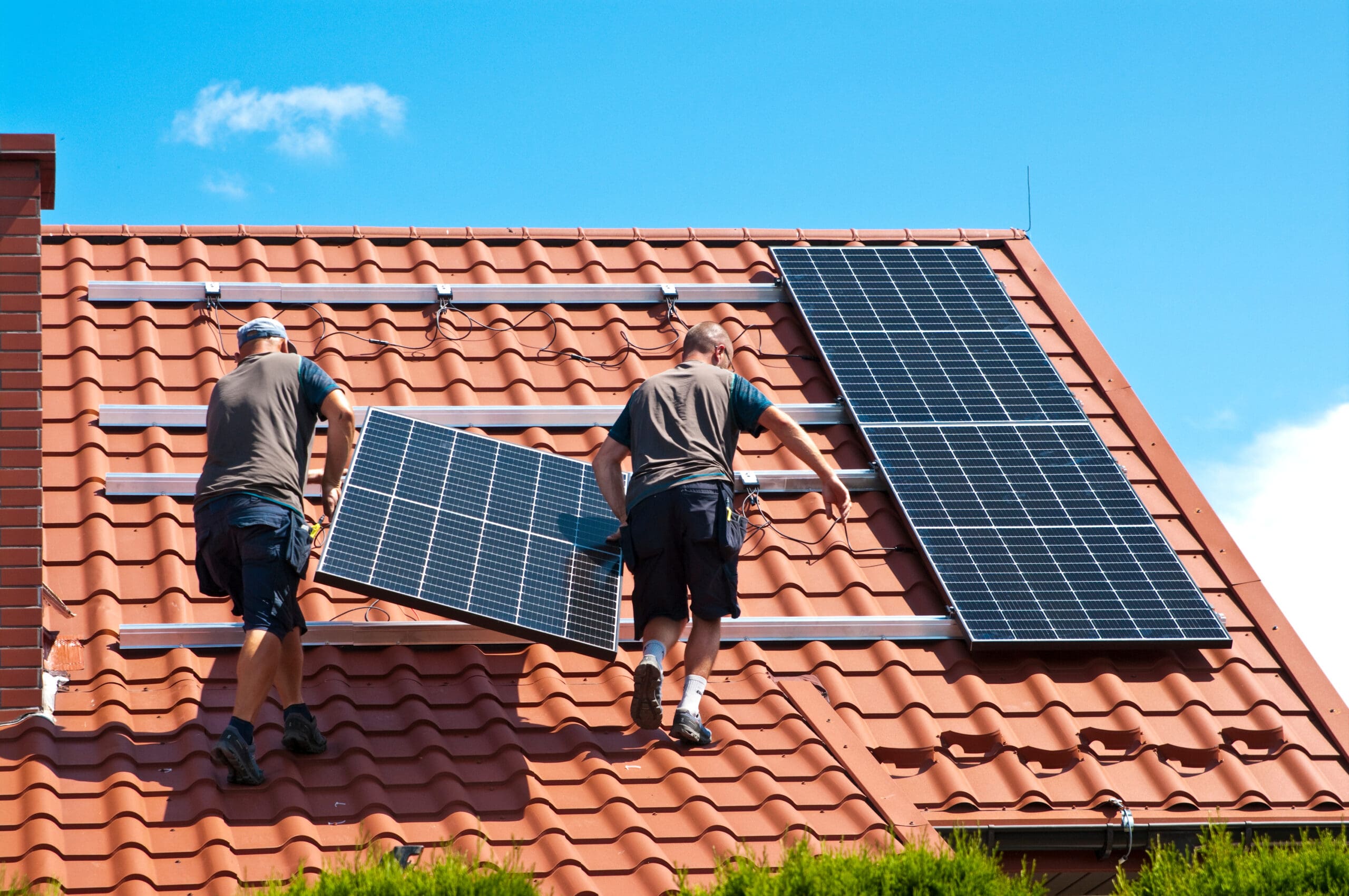 Photo de personnes en train d'installer des panneaux photovoltaïques